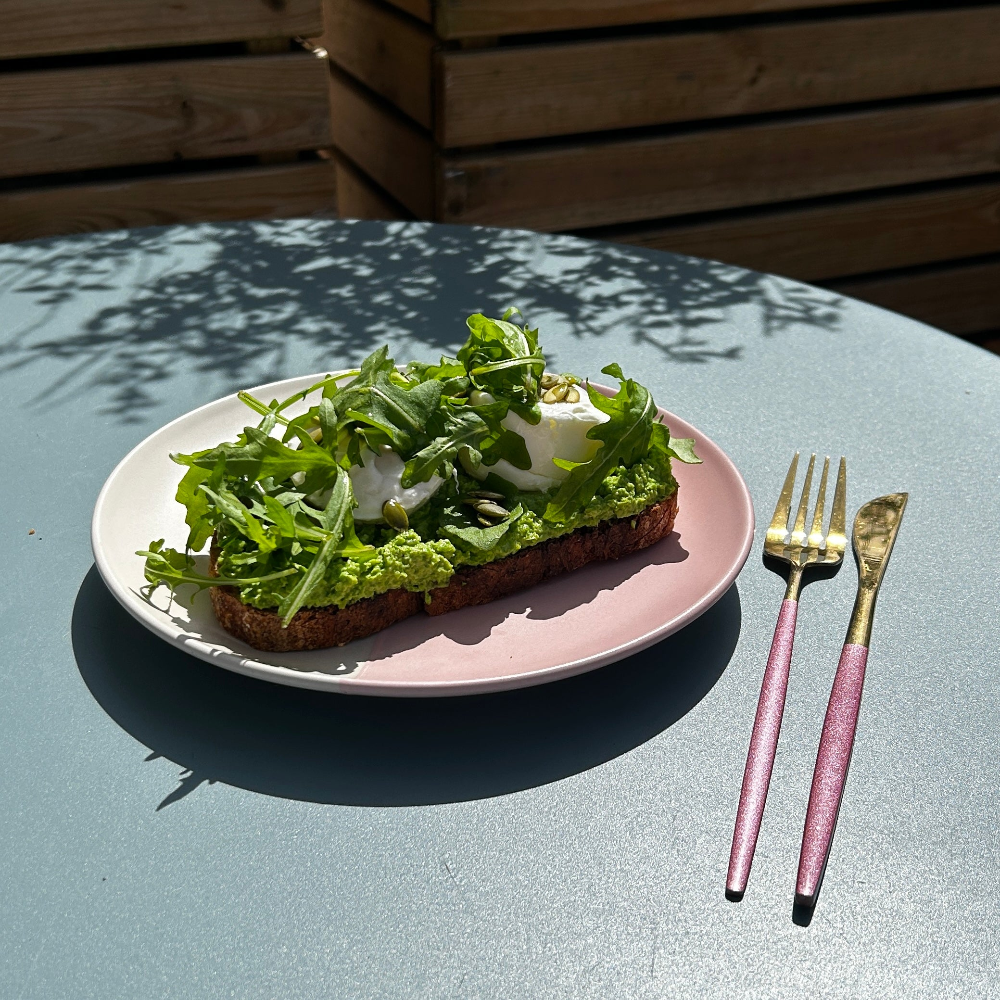 On a pale blue table sits a pink plate,