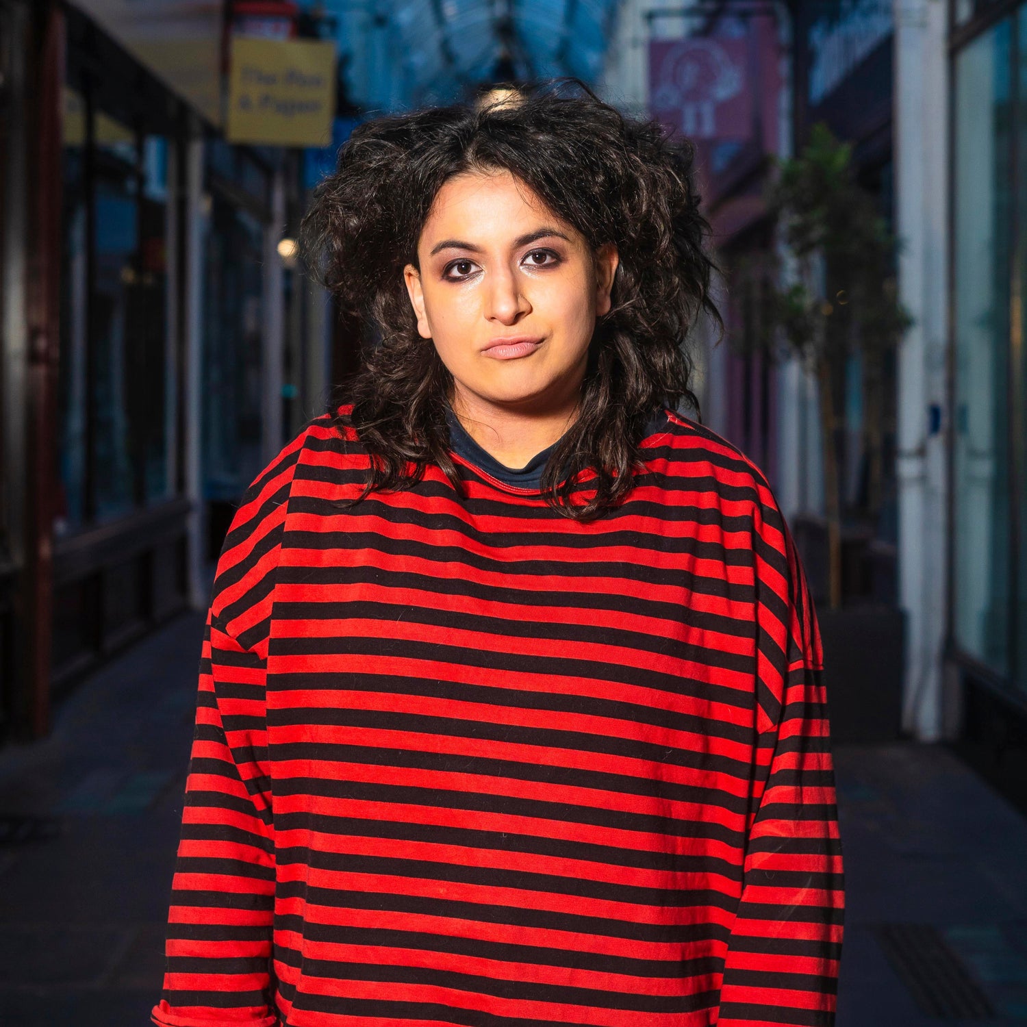 Leila Navabi in a red and black striped 